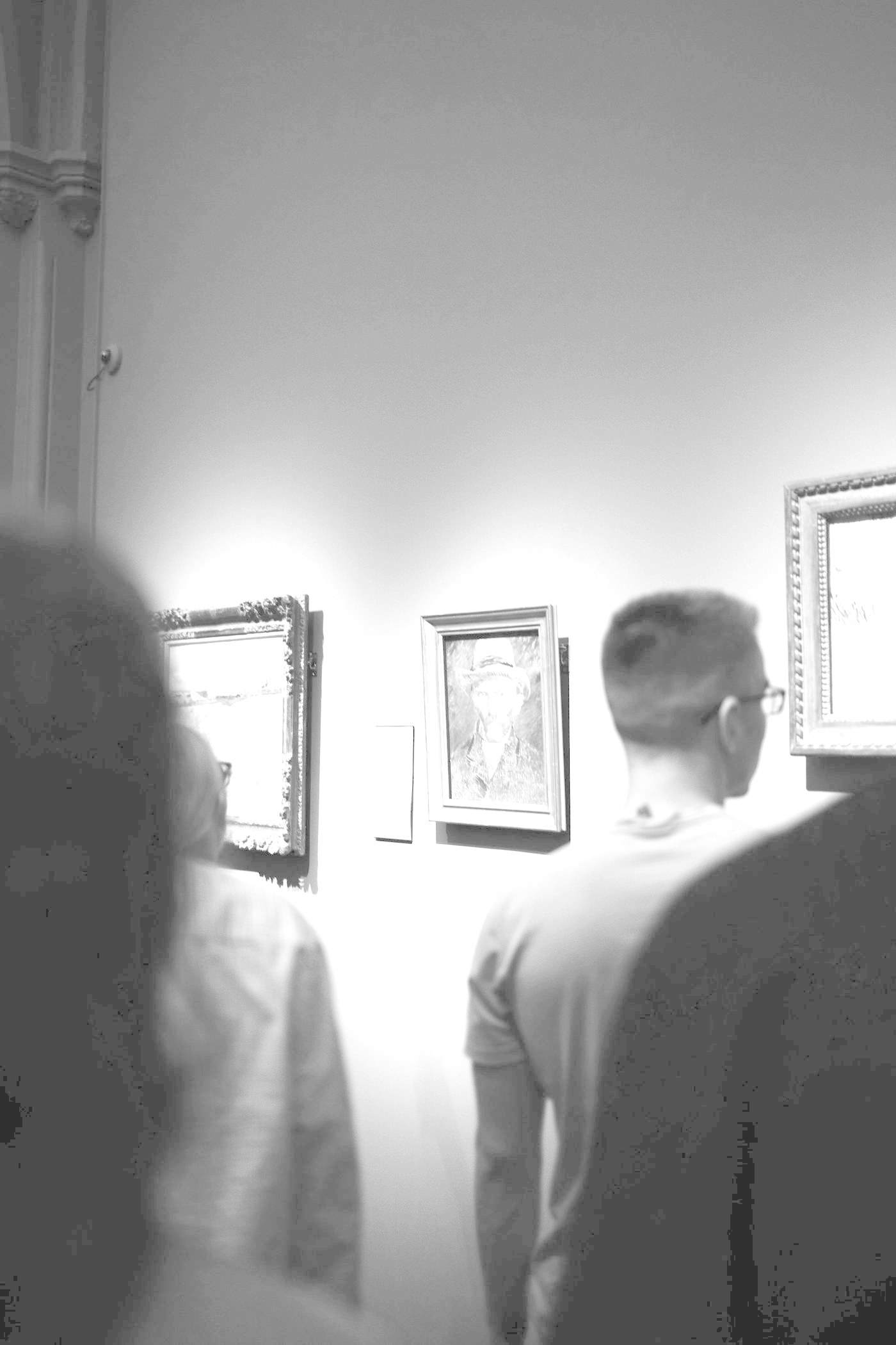 People looking at paintings in a gallery